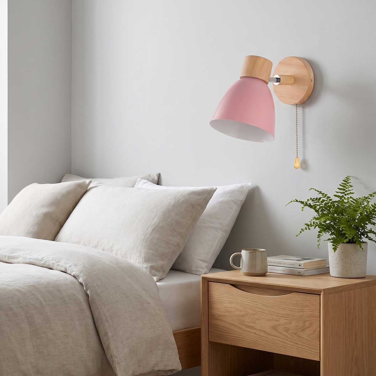 Pull-chain sconce beside a bed