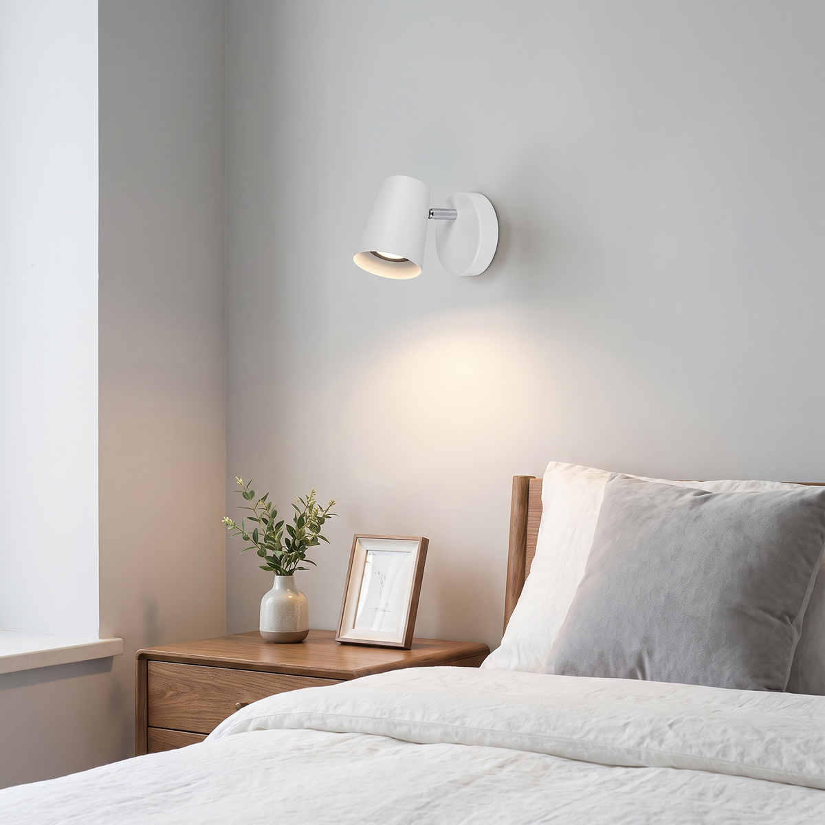 Nordic sconce beside a bed