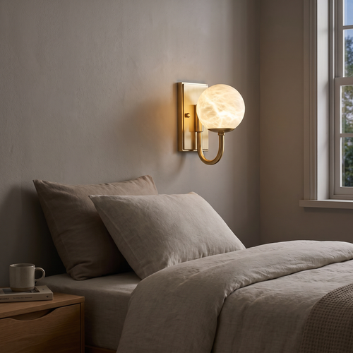 Alabaster Globe Curved Arm Wall Lamp in a bedroom